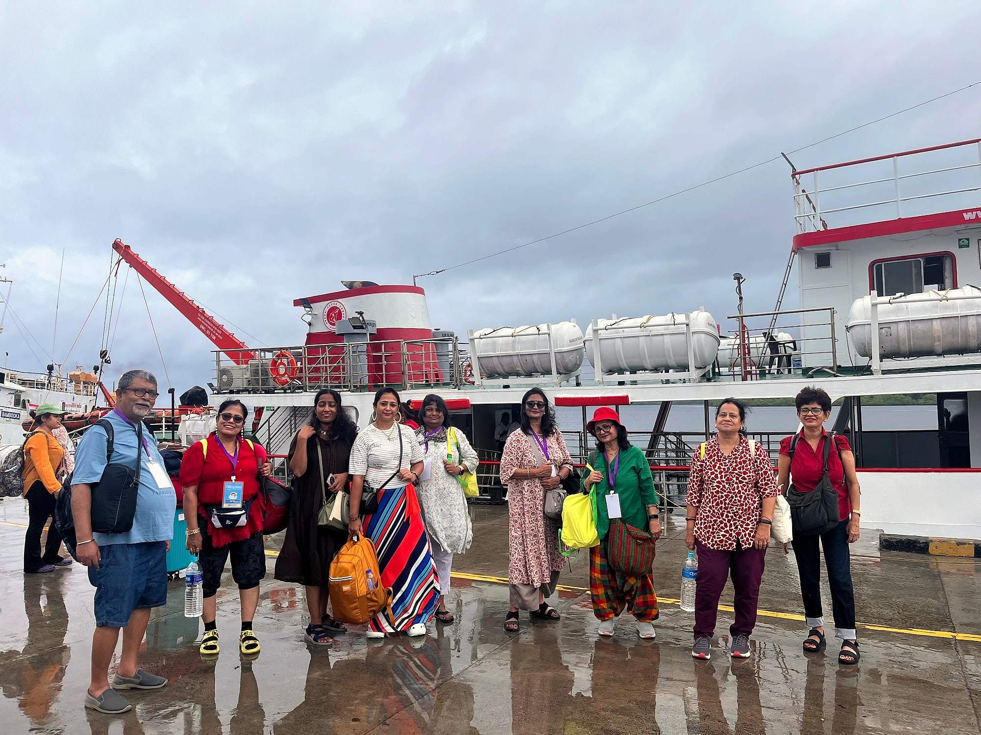 An ECHEPURON group on a wet harbour jetty in front of a passenger ship