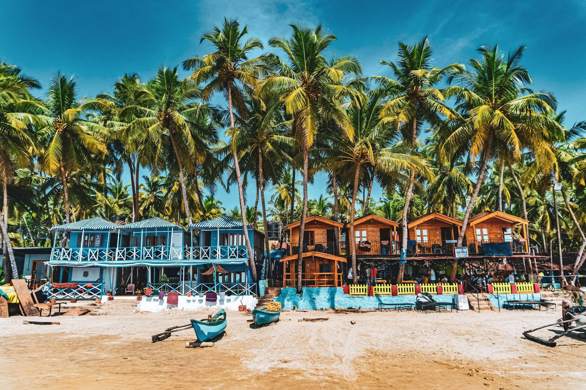 Colourful beach shacks beneath coconut palms in Goa